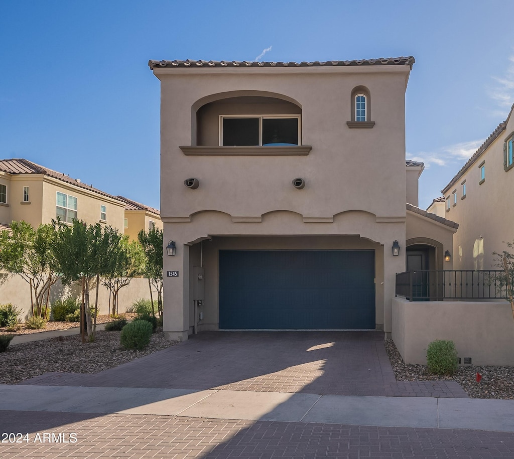 mediterranean / spanish-style house featuring a garage