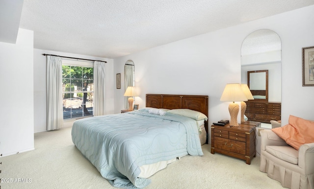 carpeted bedroom featuring a textured ceiling