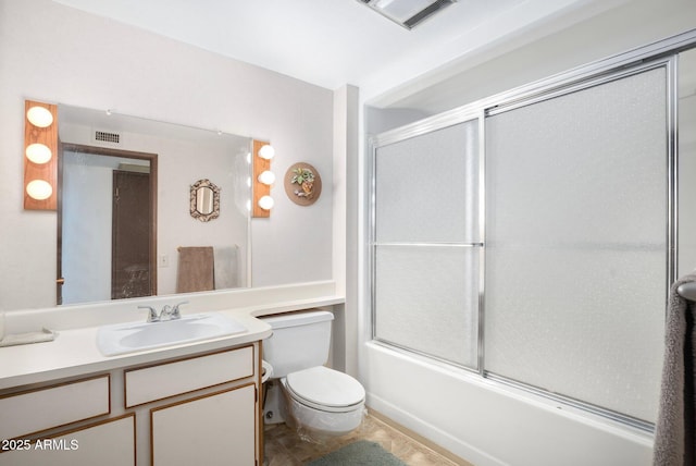 full bathroom featuring vanity, toilet, and shower / bath combination with glass door