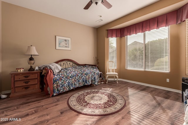 bedroom with dark wood-type flooring and ceiling fan