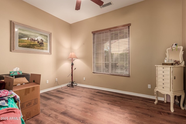 living area with ceiling fan and dark hardwood / wood-style flooring