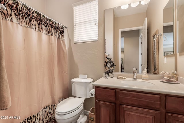 bathroom featuring toilet and vanity