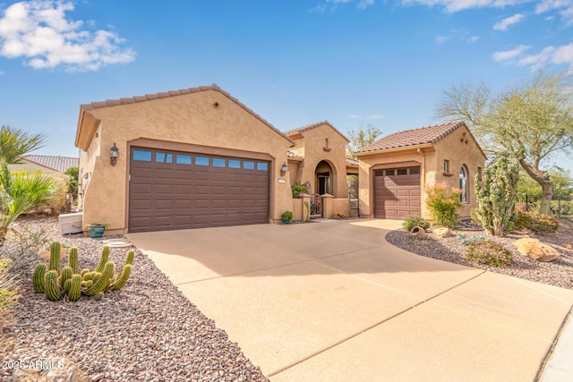 mediterranean / spanish-style home with a garage