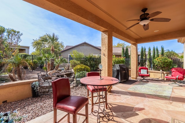 view of patio with ceiling fan and a grill