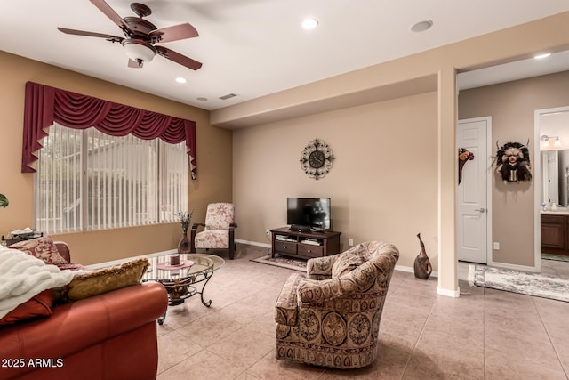 tiled living room with ceiling fan