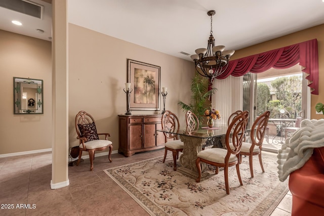 dining space featuring tile patterned floors and an inviting chandelier