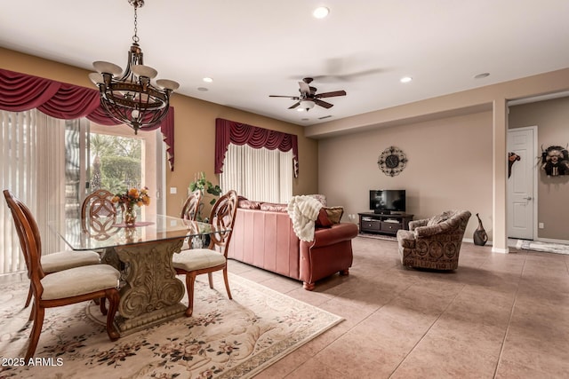 tiled dining area featuring ceiling fan with notable chandelier