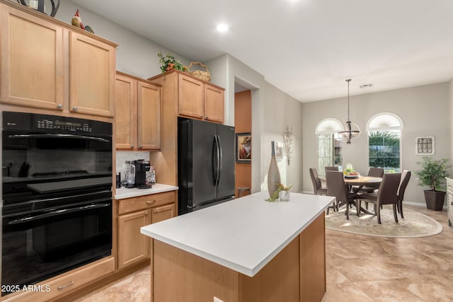 kitchen featuring visible vents, a kitchen island, hanging light fixtures, black appliances, and light countertops