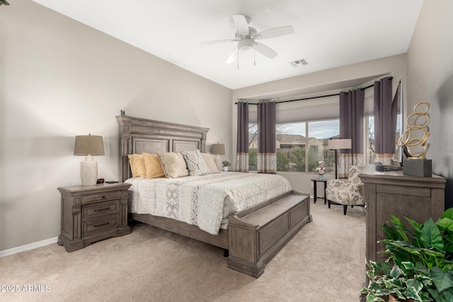 bedroom featuring visible vents, baseboards, light colored carpet, and a ceiling fan