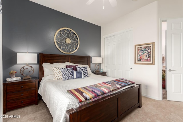 bedroom featuring a ceiling fan, light colored carpet, baseboards, and a closet