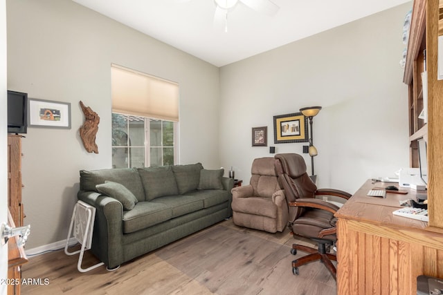 office space featuring a ceiling fan, wood finished floors, and baseboards