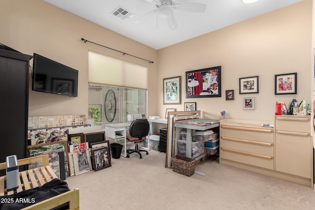 office area with light carpet, visible vents, and a ceiling fan