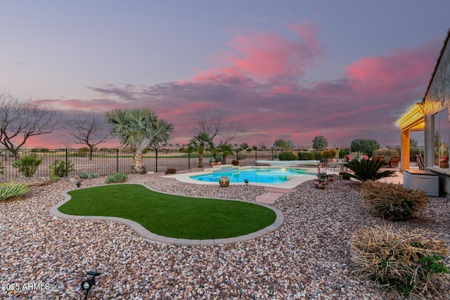 pool at dusk featuring a fenced in pool, a fenced backyard, and a patio area