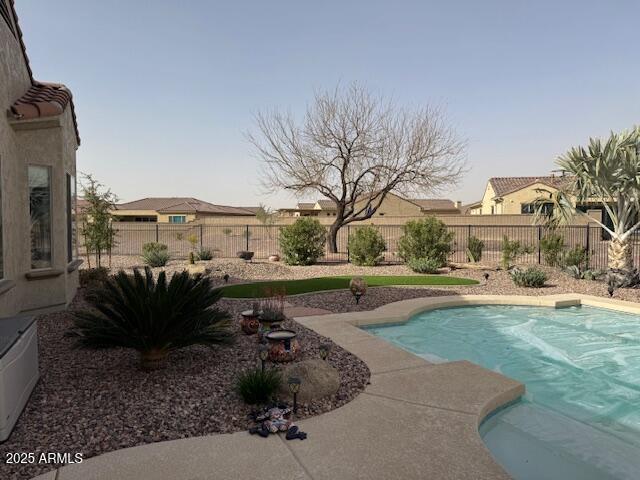 view of swimming pool featuring a fenced in pool and a fenced backyard