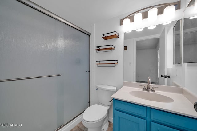 bathroom with a shower with door, vanity, and toilet