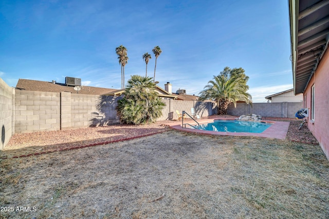 view of yard with a fenced in pool