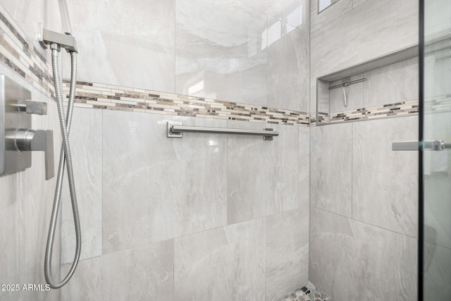 bathroom with tiled shower