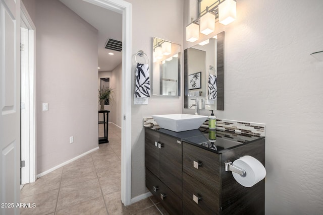 bathroom featuring vanity, tile patterned floors, and backsplash