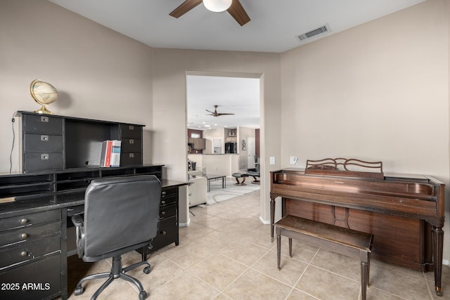 tiled office space featuring ceiling fan