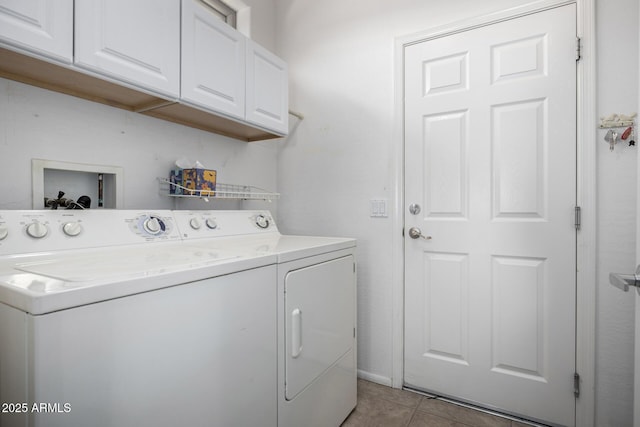 laundry area with cabinets, light tile patterned floors, and washer and dryer