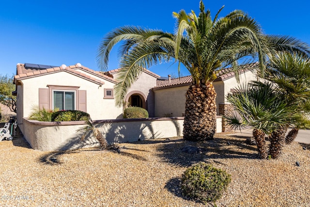 mediterranean / spanish-style home with solar panels