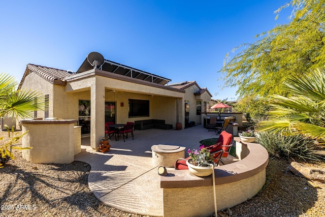 rear view of property with a patio and an outdoor hangout area