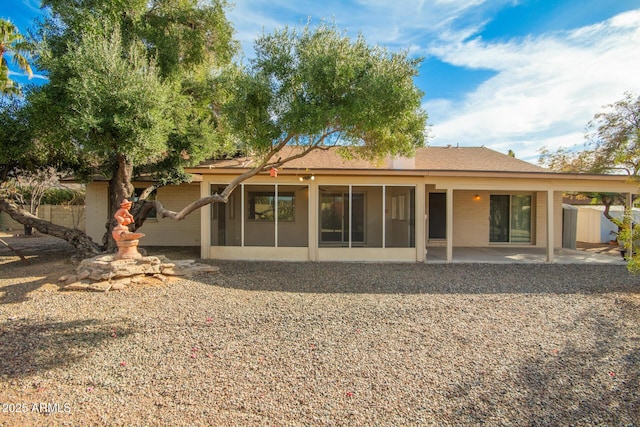 rear view of property featuring a patio area and a sunroom