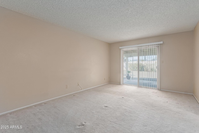 carpeted spare room featuring a textured ceiling