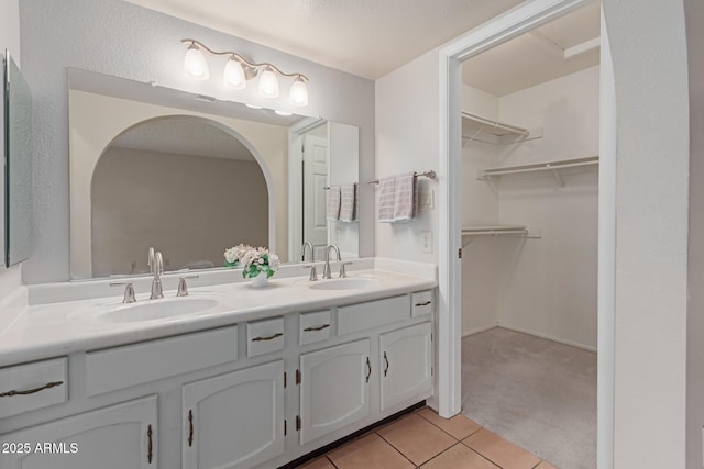 bathroom with tile patterned floors and vanity