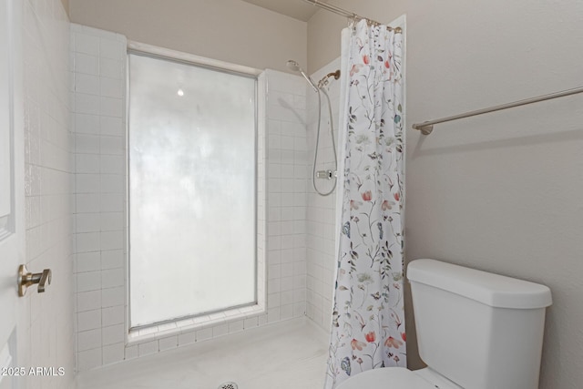 bathroom with a shower with curtain and toilet