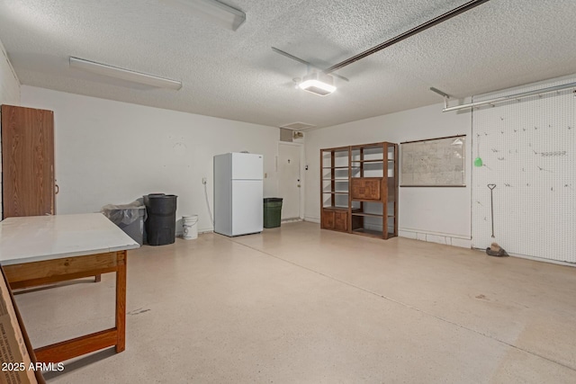 garage featuring white fridge