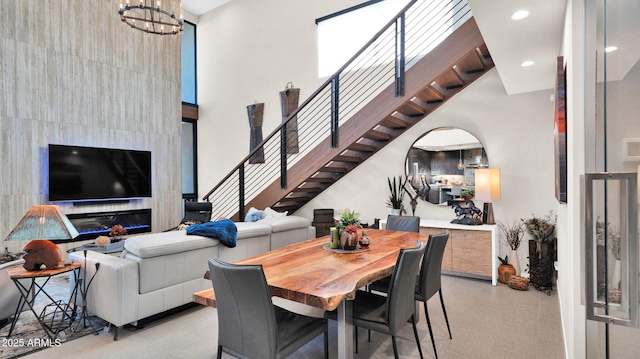 6525 E Cave Creek Rd Unit 40, Cave Creek, AZ 85331 - dining space with stairs, a towering ceiling, a chandelier, arched walkways, and recessed lighting