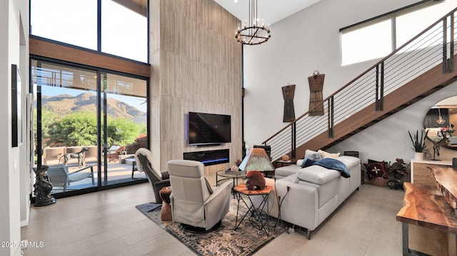 6525 E Cave Creek Rd Unit 40, Cave Creek, AZ 85331 - living area featuring a high ceiling, stairs, plenty of natural light, and a chandelier