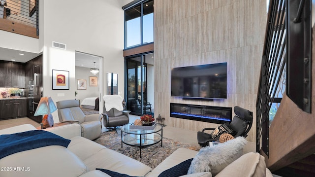 6525 E Cave Creek Rd Unit 40, Cave Creek, AZ 85331 - living room featuring a glass covered fireplace and a towering ceiling