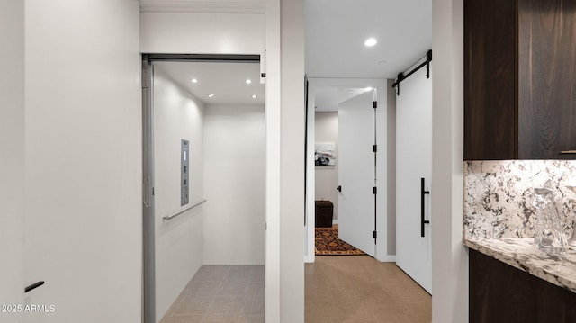 6525 E Cave Creek Rd Unit 40, Cave Creek, AZ 85331 - hallway featuring a barn door, elevator, light colored carpet, and recessed lighting