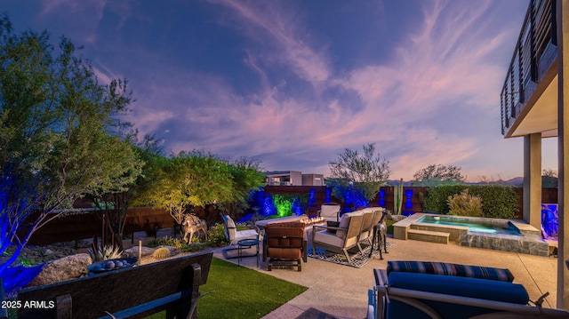 6525 E Cave Creek Rd Unit 40, Cave Creek, AZ 85331 - patio terrace at dusk featuring a fire pit, a patio, an in-ground hot tub, and a fenced backyard
