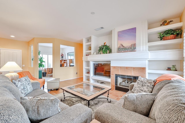 tiled living room with a fireplace and built in shelves