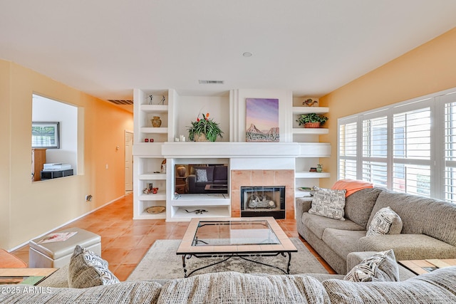 tiled living room with built in shelves and a fireplace