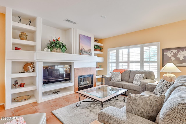 tiled living room with built in shelves and a tile fireplace