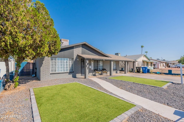2022 W Aster Dr, Phoenix, AZ 85029 - rear view of property with a porch, brick siding, and a chimney