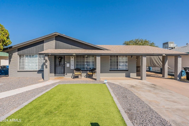 2022 W Aster Dr, Phoenix, AZ 85029 - view of front of property with covered porch, concrete driveway, central AC unit, and roof with shingles