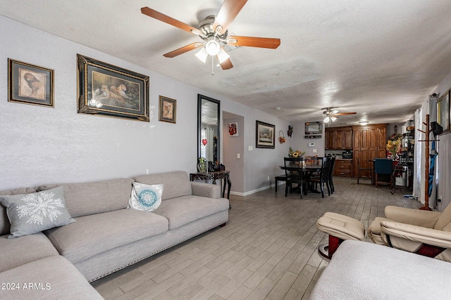 2022 W Aster Dr, Phoenix, AZ 85029 - living area featuring a ceiling fan, light wood-type flooring, a textured ceiling, and baseboards