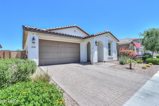 21595 S 225th Way, Queen Creek, AZ 85142 - mediterranean / spanish-style house with a tiled roof, decorative driveway, fence, an attached garage, and stucco siding