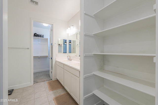 21595 S 225th Way, Queen Creek, AZ 85142 - bathroom featuring tile patterned flooring, vanity, baseboards, a spacious closet, and visible vents