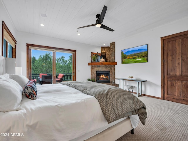 bedroom with a stone fireplace, recessed lighting, carpet flooring, wood ceiling, and access to outside