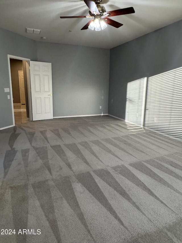 spare room with carpet flooring and ceiling fan