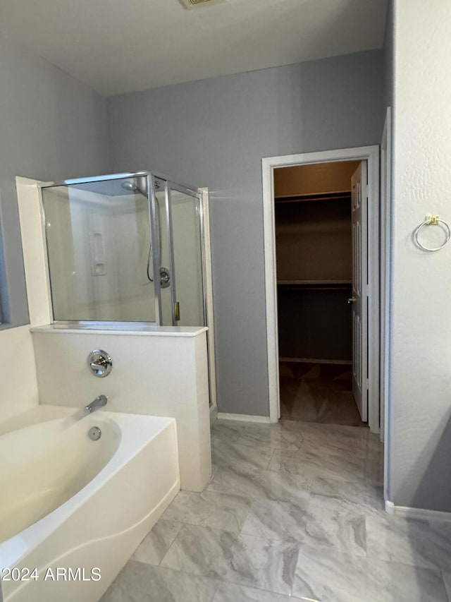 bathroom with separate shower and tub