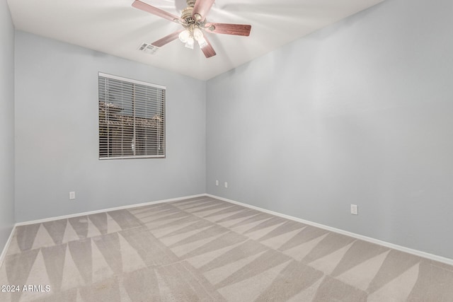 unfurnished room with ceiling fan and light colored carpet