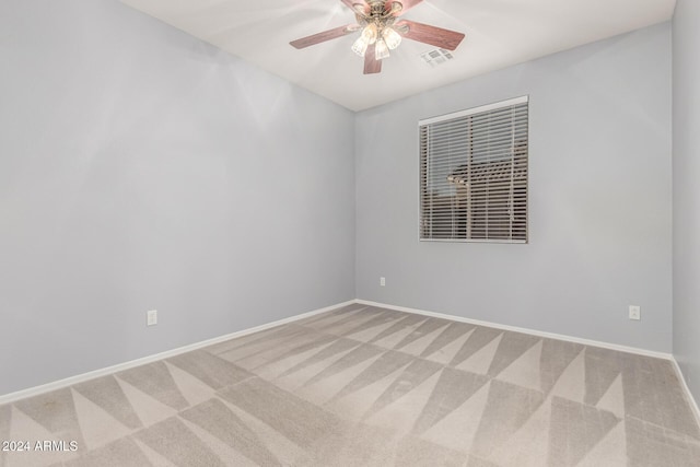 unfurnished room featuring ceiling fan and carpet floors