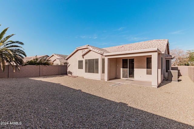 rear view of property with a patio area and central air condition unit